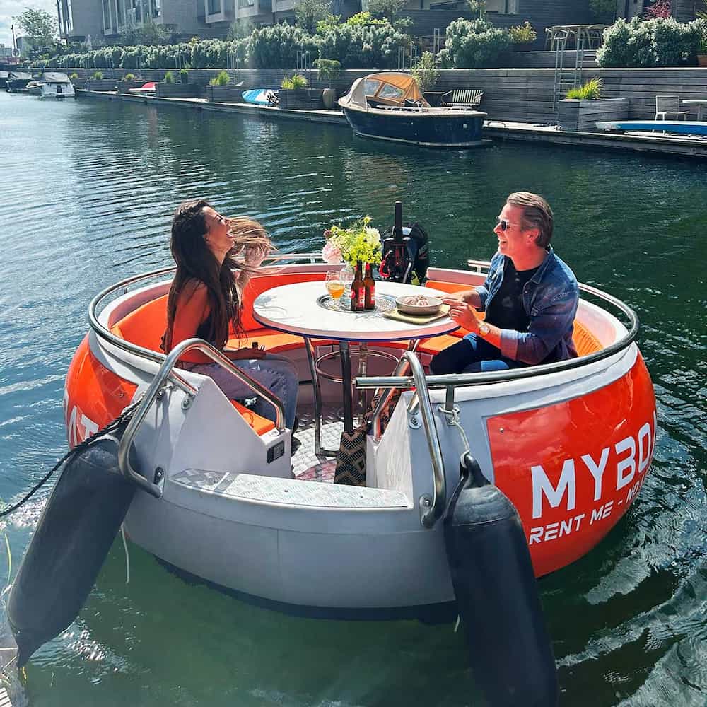 Paar genießt Essen und Getränke auf einem MyBoat-Donutboot in Kopenhagen